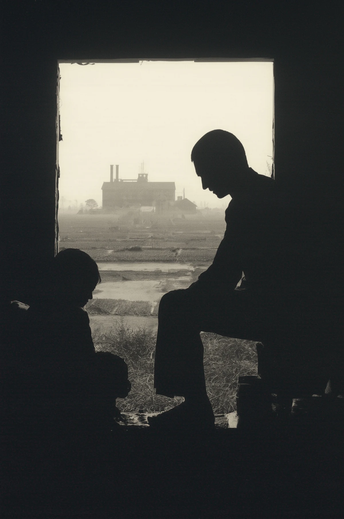 Two people sit in silhouette beside a window overlooking an industrial skyline.